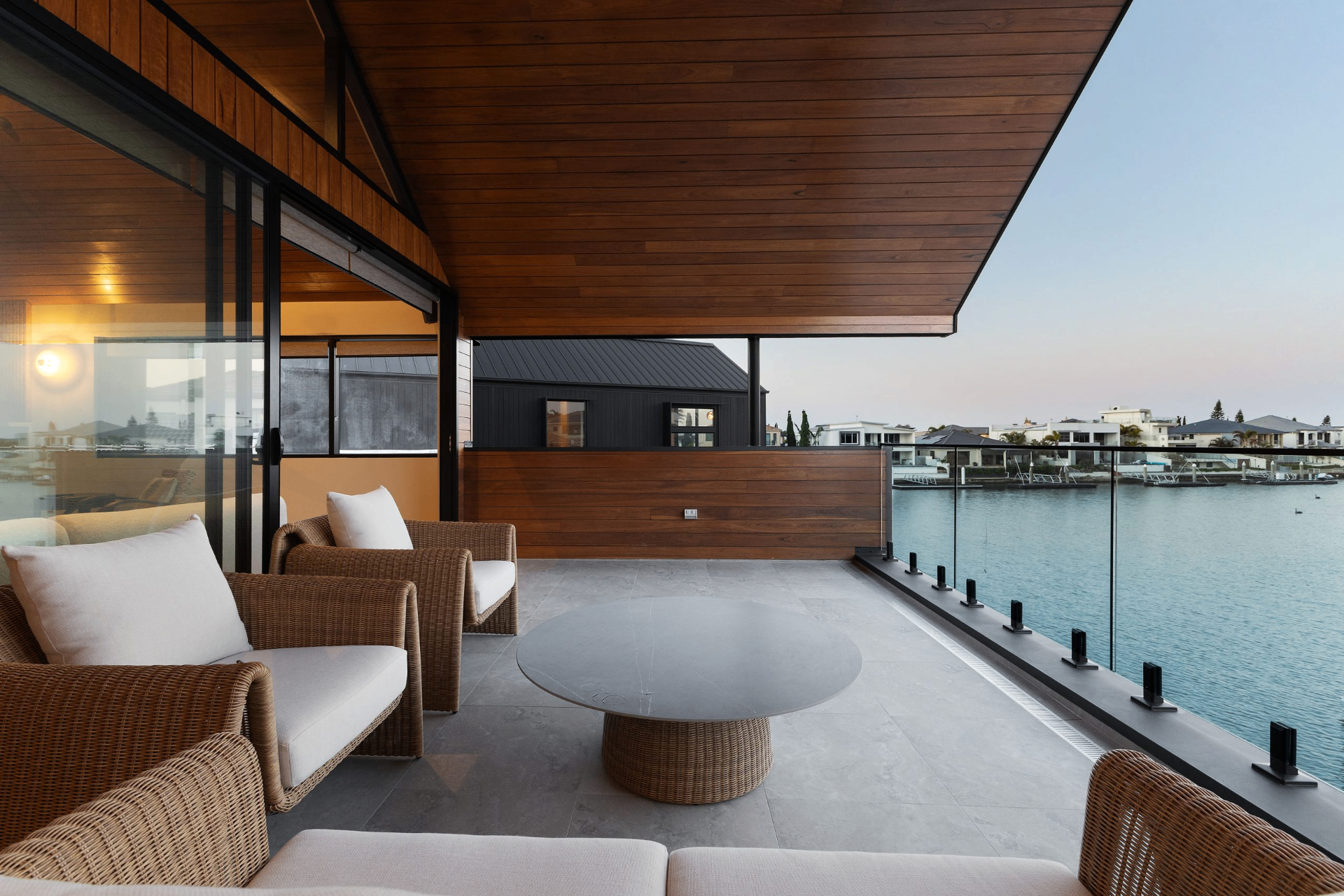 Waterfront balcony of a Nikal luxury residence at dusk